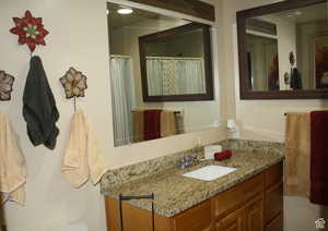 Bathroom with curtained shower and vanity