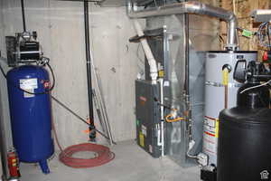 Utility room with air compressor, water heater, furnace and water softner