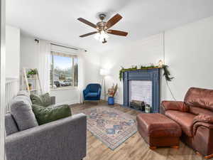 Living room with ceiling fan and wood-style flooring