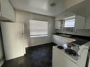 Kitchen with cooling unit, sink, white cabinets, and white appliances