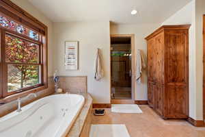 Bathroom featuring plus walk in shower