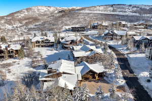 Snowy aerial view featuring a mountain view