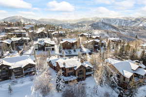 Snowy aerial view featuring a mountain view