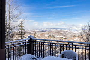 Snow covered back of property featuring a mountain view