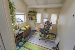 Home office featuring vaulted ceiling