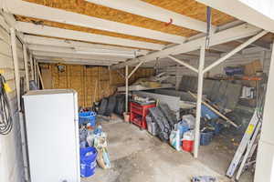 Garage featuring fridge