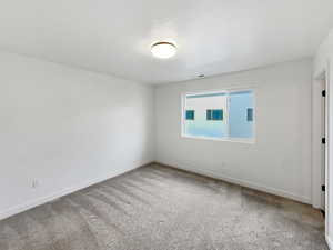 Unfurnished room featuring carpet