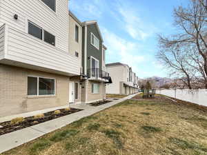 View of yard featuring a mountain view and a balcony