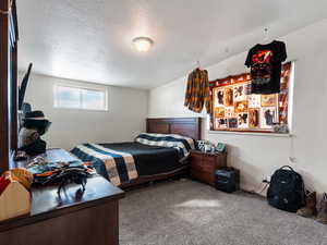 Bedroom featuring a textured ceiling and carpet floors