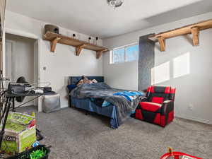 Bedroom featuring carpet and a textured ceiling