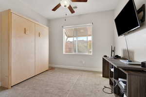 Carpeted office with ceiling fan