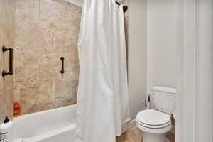 Bathroom with shower / bath combo and toilet