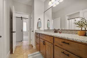 Bathroom featuring tile patterned flooring and vanity