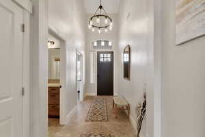 Entryway with a towering ceiling and an inviting chandelier