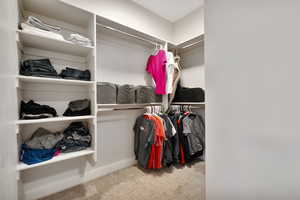 Spacious closet with carpet