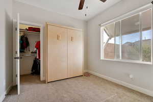 Unfurnished bedroom with carpet flooring and ceiling fan