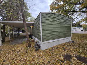 View of side of property with a carport