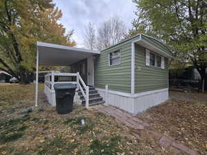 View of side of home with a carport