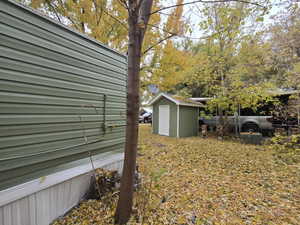 View of yard featuring a storage unit