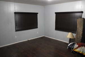 Unfurnished room with dark hardwood / wood-style floors