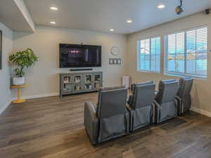 Living room with dark hardwood / wood-style floors and a textured ceiling