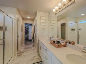 Bathroom with vanity, a textured ceiling, toilet, and a shower with shower door