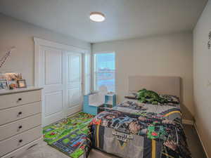 Bedroom featuring carpet floors and a textured ceiling