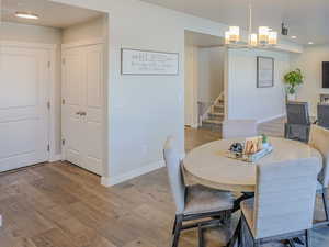 Dining area featuring light hardwood / wood-style floors and a chandelier