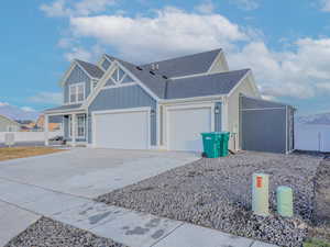 View of property exterior with a mountain view and a garage