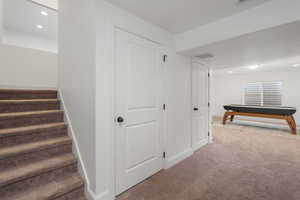 Staircase featuring carpet floors