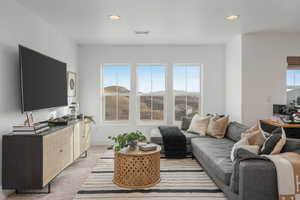 Living room with a mountain view and light colored carpet