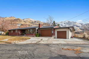 Single story home with a mountain and valley views and a garage