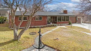 Ranch-style house with a garage and a front yard