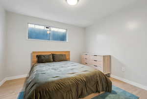 Bedroom with light hardwood / wood-style flooring