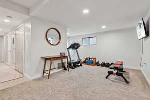 Exercise room with light colored carpet