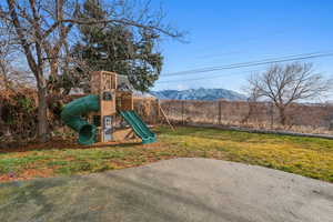 Exterior space featuring a mountain view and a playground