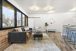 Living room featuring wood-type flooring and a barn door