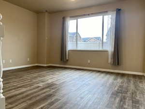 Empty room with dark wood-type flooring