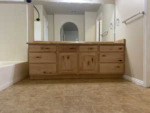 Bathroom with sink, bathtub / shower combination, and tile patterned flooring