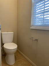 Bathroom featuring tile patterned flooring and toilet