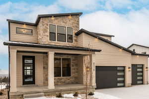 Modern home with a porch and a garage