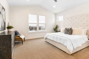 Carpeted bedroom with vaulted ceiling