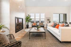 Living room featuring a tiled fireplace and wood-type flooring