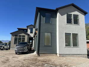 View of front of property with stucco siding and a mountain view