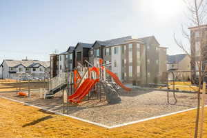 View of playground with a lawn