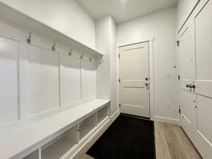 Mudroom with light hardwood / wood-style floors