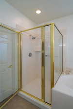 Bathroom featuring tile patterned floors and shower with separate bathtub