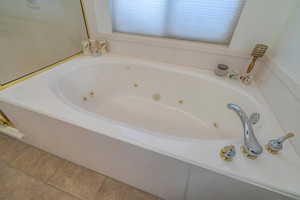 Bathroom featuring tile patterned floors and jetted bathtub