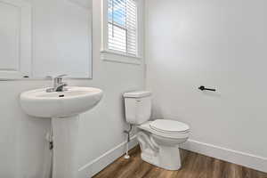 Bathroom featuring hardwood / wood-style floors and toilet