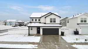 View of front of property featuring a garage